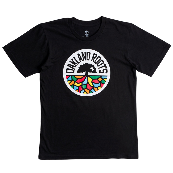The Oakland Roots SC Classic Tee by Oakland Roots SC is a black t-shirt featuring a circular logo in the center. The logo displays a black tree encircled by the text "OAKLAND ROOTS" in white. Beneath the tree's roots, you'll find colorful geometric shapes in red, green, yellow, and blue, symbolizing the social good values of Oakland Roots Sports Club.