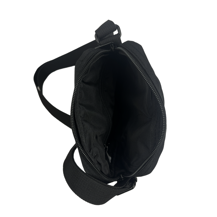 The Oakland Roots SC Flight Bag is a black crossbody bag featuring two adjustable straps and a zippered main compartment, viewed from the top. The bag is open, revealing a spacious interior lined with black fabric. With its simple and minimalist design, it’s suitable for casual or everyday use—ideal for showing off your Oakland Roots SC pride.