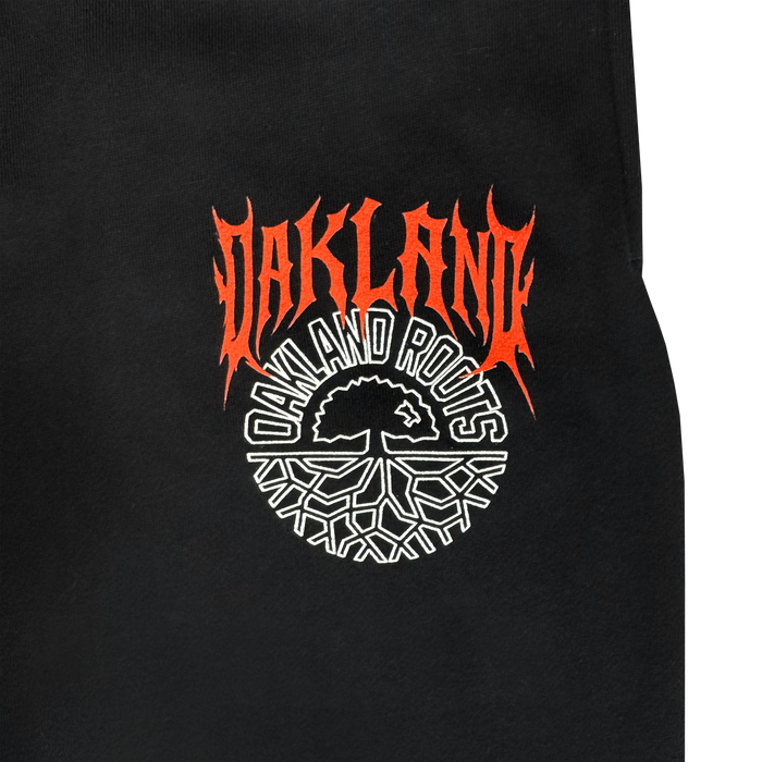 Black fabric with bold, red, flame-styled "OAKLAND" over "OAKLAND ROOTS" in white, plus a circular white tree logo. Style pairs perfectly with the Oakland Roots SC Forge Pant. Men's sizes available from Oakland Roots SC.