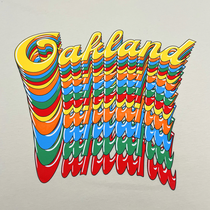 Featuring colorful, distorted 3D text that repeats “Oakland” in vibrant layers of yellow, blue, red, green, and orange, the Oakland Roots SC Funk Tee by Other creates a wavy, psychedelic effect on a light background. Each layer drifts downward for an energetic rippled look—perfect for celebrating Oakland’s dynamic spirit and showing your support for the Roots Sports Club.