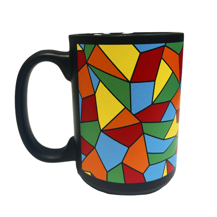 Introducing the Oakland Roots SC Mosaic Coffee Mug by Oakland Roots SC—this ceramic coffee mug features a striking black handle and showcases a vibrant, multicolored geometric design. Reminiscent of stained glass, the pattern consists of irregular polygons in red, green, blue, yellow, and orange. Ideal for Oakland Roots fans or any sports club enthusiast seeking a stylish way to enjoy their brew.