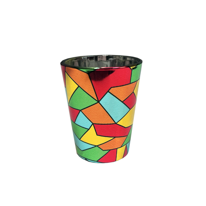The Oakland Roots SC Mosaic Shot Glass by Oakland Roots SC showcases a geometric pattern inspired by the Oakland Roots Sports Club. The design is composed of interlocking shapes in vivid colors like red, orange, yellow, green, blue, and black, forming a lively and striking mosaic effect. The interior of the shot glass has a metallic and reflective appearance.