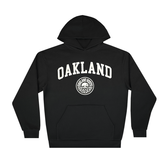 The Oakland Roots SC University Hoodie is a men’s black pullover featuring bold “OAKLAND” in white, a circular “OAKLAND ROOTS” logo, front pocket, and ribbed cuffs. Brand: Oakland Roots SC.