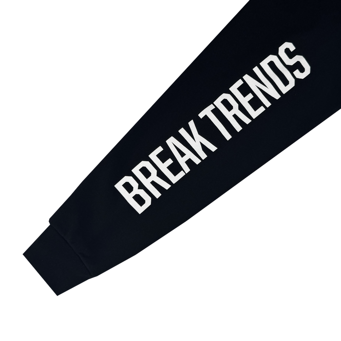 A close-up of the Oakland Roots SC X Break Free Hoodie sleeve shows "BREAK TRENDS" in bold white letters on black fabric, against a plain white background.