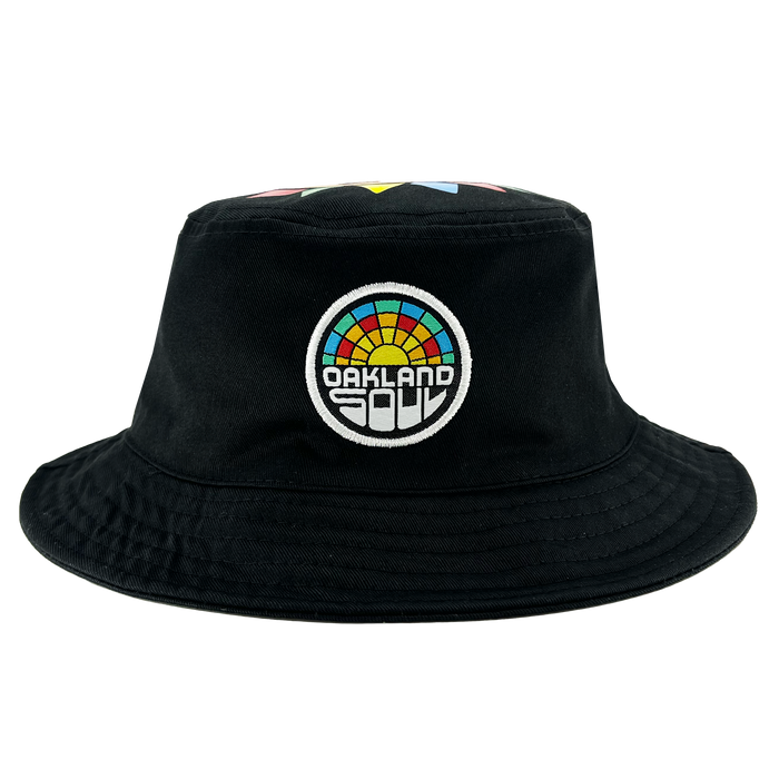 Introducing the Oakland Soul & Roots SC Reversible Bucket from Oakland Roots SC—a stylish black bucket hat that boasts a vibrant embroidered patch on the front. The circular patch features a rainbow of colors and displays the words "OAKLAND SOUL" within it. With its wide brim and robust, simple fabric, this hat offers both casual elegance and sturdy functionality.