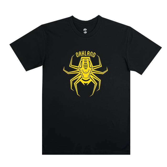 Introducing the Oakland Spiders Logo Tee by Supported Brands: a black T-shirt adorned with a striking yellow spider graphic prominently displayed on the front. The intricate, segmented spider is complemented by the bold yellow text "Oakland Spiders" printed above it, making it an ideal choice for supporting your favorite ultimate frisbee team or enjoying family-friendly events.