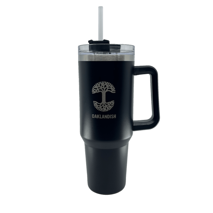 Front view of a black double walled 40-oz stainless steel travel drink tumbler with silver Oaklandish log and wordmark, airtight lid and reusable straw.