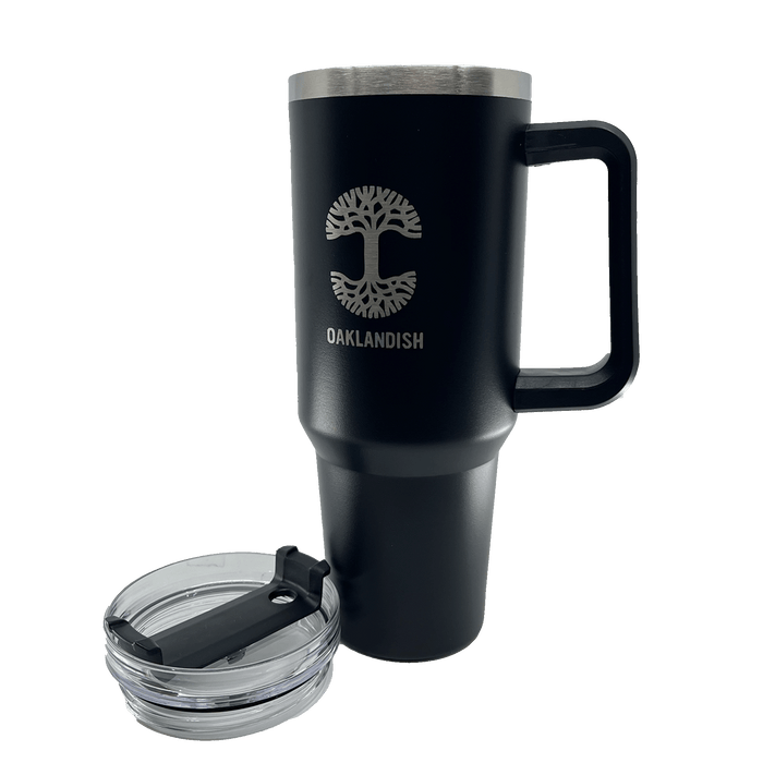 Front view of a black double walled 40-oz stainless steel travel drink tumbler with silver Oaklandish log and wordmark, and airtight lid sitting to the side.