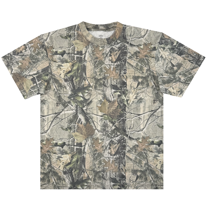 The Oaklandish Camo Tree Tee by Oaklandish is an oversized fit t-shirt with a Tree Camo pattern featuring green, brown, and tan leaves and branches. Made from heavyweight cotton, it boasts a full coverage woodland theme across the shirt, including sleeves and neckline.