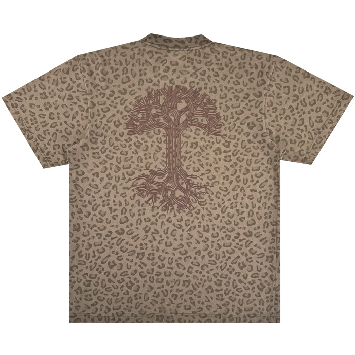 The Oaklandish Classic Logo Tee by Oaklandish is a brown men's oversized short-sleeve t-shirt with an all-over leopard print, made from heavyweight cotton. It features a large dark brown tree logo with many roots on the back.