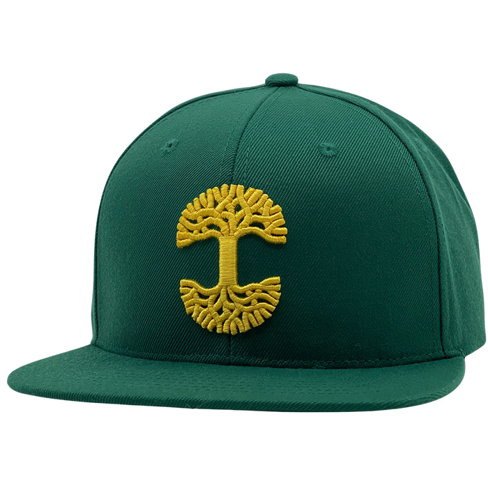 The Oaklandish Classic Snapback by Oaklandish is a dark green hat with a flat brim, featuring a prominent yellow embroidered tree emblem on the front panel. This emblem showcases a symmetrical, stylized design, while the snapback itself boasts meticulous stitching details on both the crown and brim.