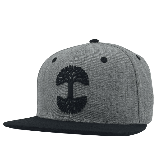 The Oaklandish Classic Snapback, crafted by Oaklandish, boasts a gray design featuring a black brim and a striking embroidered tree logo on the front. With ventilation eyelets at the top, it seamlessly merges style with modern sophistication.