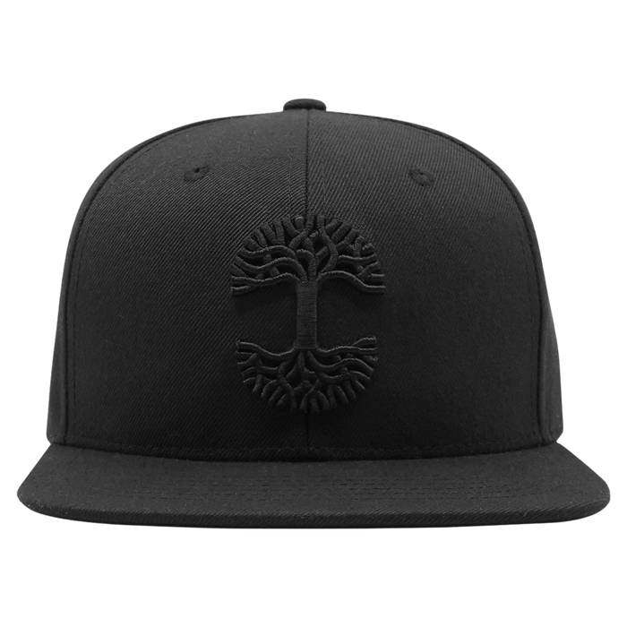 The Oaklandish Classic Snapback by Oaklandish features an embroidered black tree emblem on the front, with intricate roots and branches forming a circular pattern. This stylish headwear boasts a flat brim and is set against a plain white background.