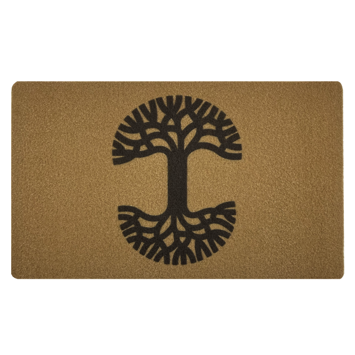 The Oaklandish Logo Door Mat by Oaklandish is a rectangular door mat with a brown background featuring a black tree design in the center. The tree has a prominent trunk, with branches extending upwards and roots spreading outwards, creating a symmetrical, mirrored effect. This mat has a textured surface for effective dirt removal and an anti-slip backing for stability indoors or outdoors.