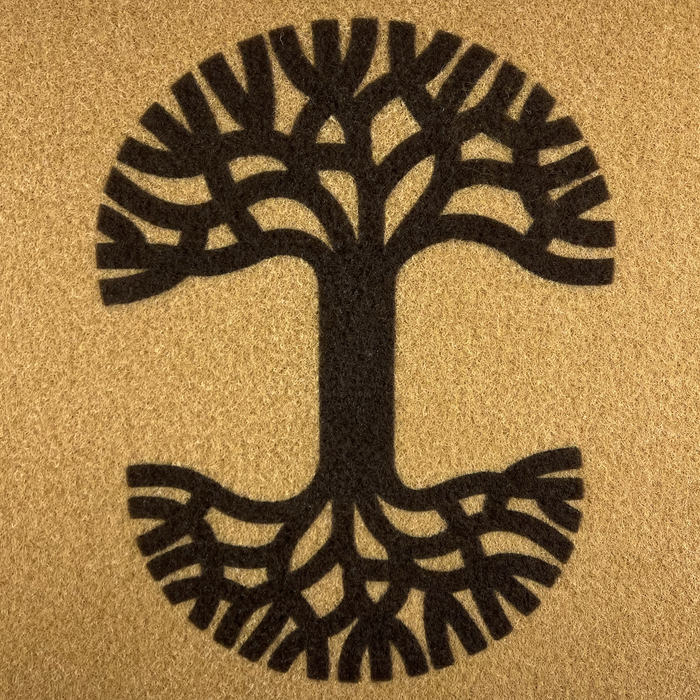The Oaklandish Logo Door Mat by Oaklandish features a stylized tree illustration centered on a textured brown background. Perfect for both indoor and outdoor use, this door mat showcases a thick trunk with symmetrical branches and roots, forming an overall circular shape. The simple, monochromatic design in dark brown includes anti-slip backing against the lighter brown backdrop.