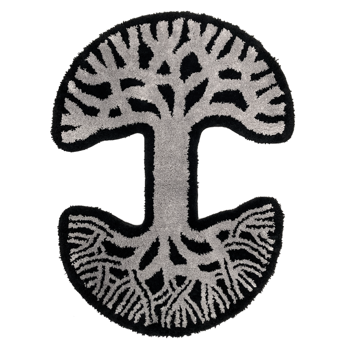 The Oaklandish Logo Rug by Oaklandish features a circular design inspired by the abstract tree logo. The rug has a striking contrast with a black background and detailed gray patterns depicting intertwined branches forming a broad canopy at the top and an intricate network of roots at the bottom.