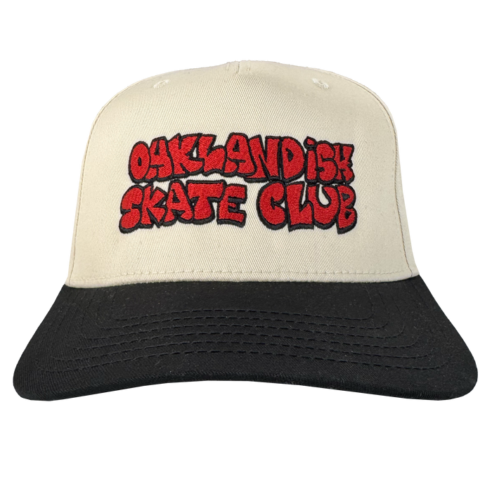 The Oaklandish Skate Club 2-Tone Hat by Oaklandish features a white crown, black brim, and bold red "OAKLANDISH SKATE CLUB" graffiti text outlined in black for a true skateboard style. Plain white background.