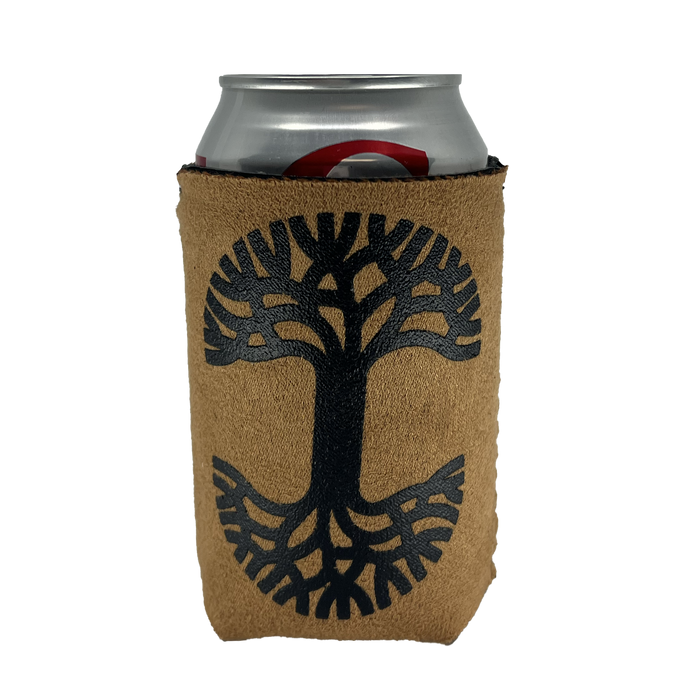 The Oaklandish Suede-ish Can Cooler by Oaklandish features a light brown, textured sleeve with a black tree design on it. The tree has large, spreading branches and roots that form a symmetrical shape resembling the letter "T". This cozy snugly fits around a silver beverage can and includes a neoprene interior for enhanced insulation.