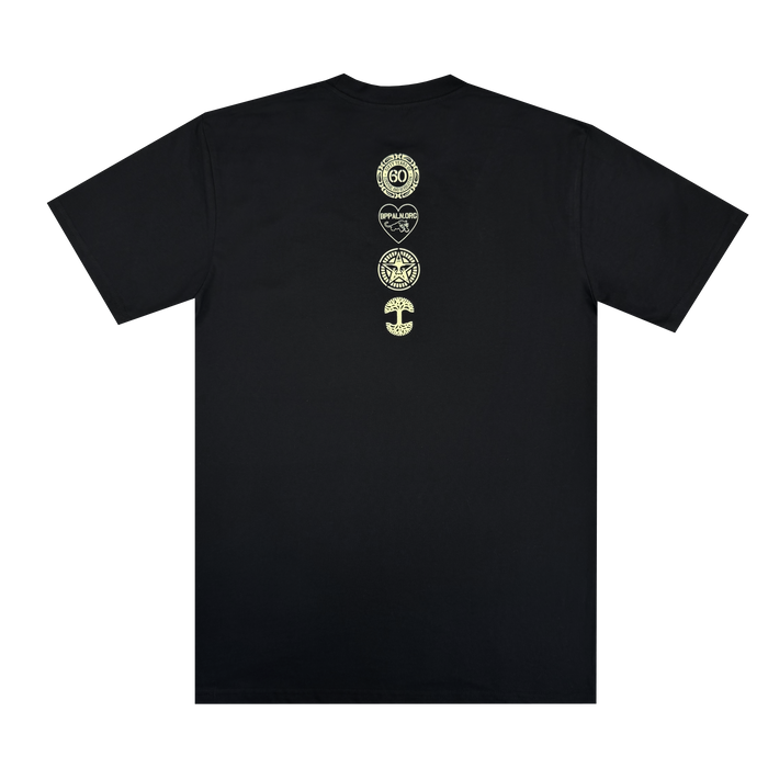 The Obey x BPPALN x Oaklandish - 60th Educate to Liberate Tee by Oaklandish is a black short-sleeve shirt with four small yellow-green symbols vertically on the upper back, laid flat on a white background.