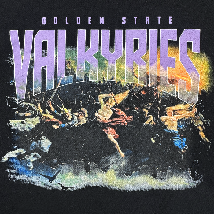 A dramatic scene of Valkyries riding horses appears beneath bold purple "Golden State Valkyries" text on the GSV Odin Hoodie, featuring women in flowing garments charging through a stormy, yellow-orange sky. Officially licensed design.