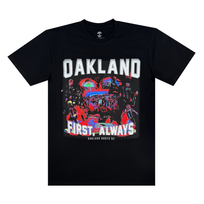 The OFA Tour Tee by Oakland Roots SC is a black T-shirt featuring "OAKLAND" in bold white letters, colorful abstract art of people and urban elements, and the phrases "FIRST. ALWAYS" and "Oakland Roots SC," highlighting the sports club's dedication to social good.