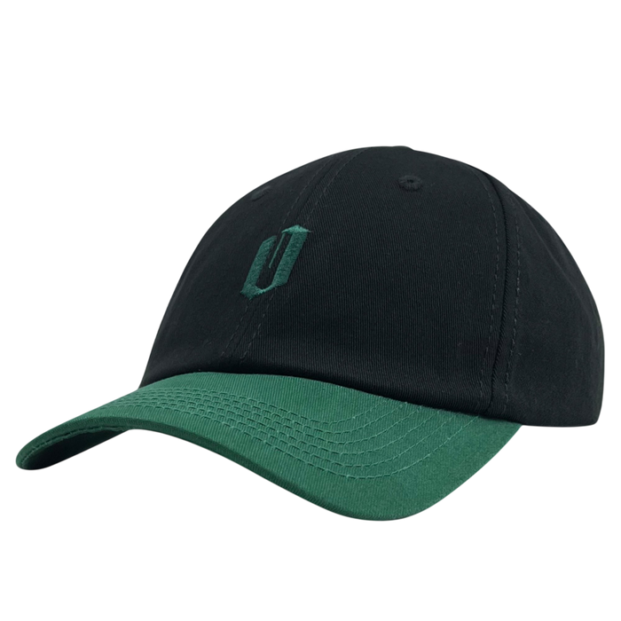 Introducing the Official Micro Logo Dad Hat by Oaklandish: a sleek black dad hat with a green visor. This cap showcases a minimalist embroidered "O" in matching green on the front, blending style with simplicity. Visible stitching on its panels and brim adds an element of detail to its overall design, making it quintessentially Oaklandish.