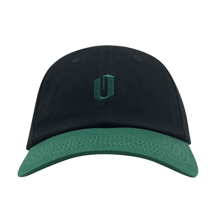 The Official Micro Logo Dad Hat from Oaklandish is a black cap featuring a dark green brim and an embroidered dark green, stylized "U" emblem on the front. Its minimalist design without any additional embellishments or logos makes it perfect for those who appreciate subtle style.