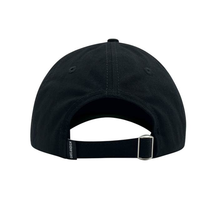 Rear view of the Official Micro Logo Dad Hat by Oaklandish in black. The cap features a central seam with visible stitching, an embroidered "O" on the side, a metal buckle on an adjustable strap, and a small rectangular tag with text on the left side of the strap. The white background highlights the cap's intricate details.