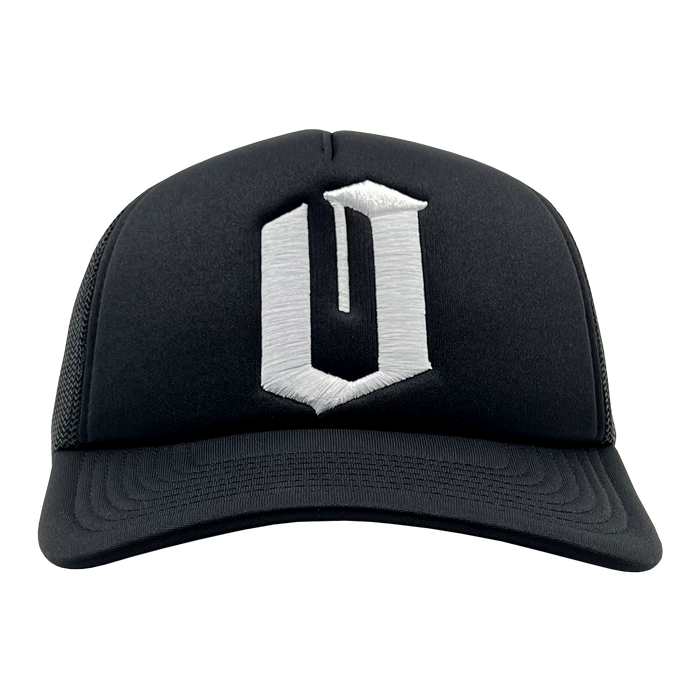 The Official O Trucker by Oaklandish is a black trucker snapback with a curved brim and mesh back. The front panel features a large, stylized, white letter "O" embroidered in a bold, three-dimensional design.