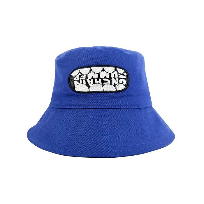 The OG Bucket Hat by Supported Brands is a bright blue hat with a front patch showing bold "UNCHAIN" lettering across white teeth. Ideal for Onchain Summit style or pairing with your favorite OG enamel pins.