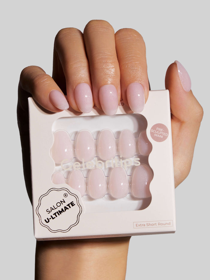 Hand holding a box of press-on nails with 'Salon U-ultimate' branding.
