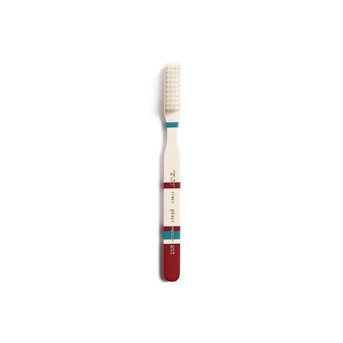 Burgundy and cream toothbrush on white background