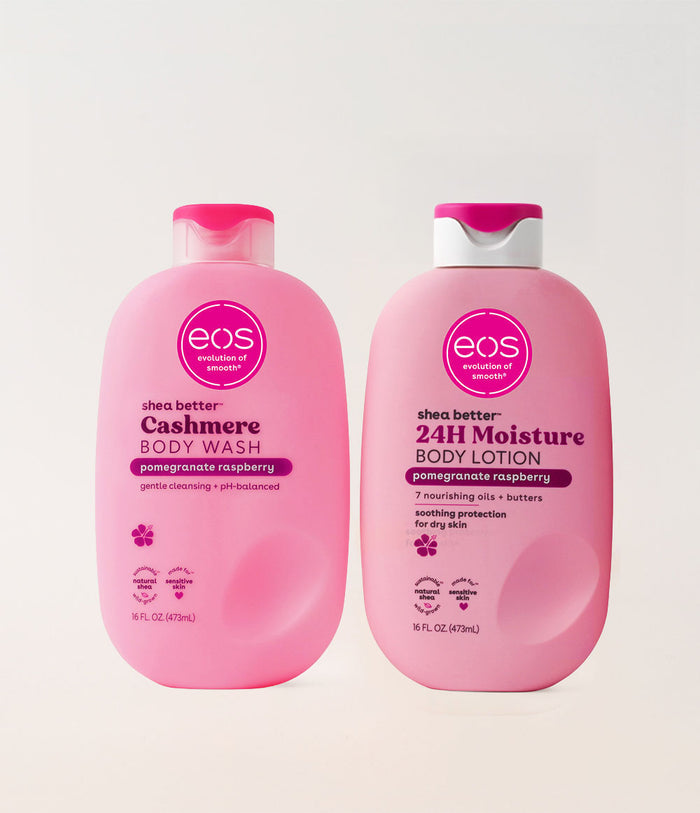 Two pink bottles of eos shea butter body wash and lotion on a white background