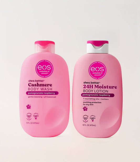 Two pink bottles of eos shea butter body wash and lotion on a white background