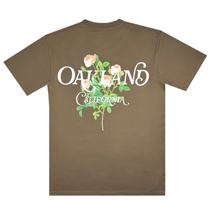 The Posy Tee from Oaklandish, part of our exclusive collection, features "Oakland California" in stylized white text on the back, complemented by a charming design of three blooming roses with green stems and leaves.