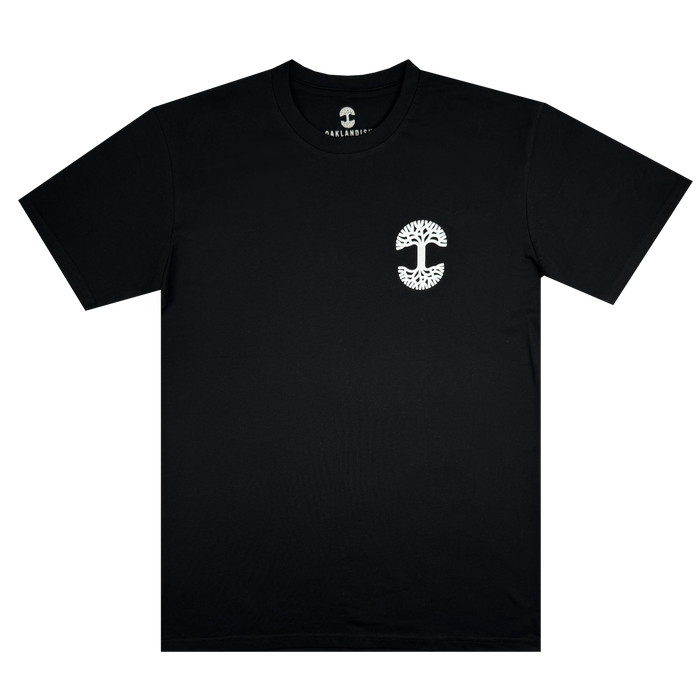 Posy Tee by Oaklandish from the men's collection features a small white tree emblem on the left chest. The emblem is circular, with intricate branches forming a tree shape. This cotton tee boasts a crew neck and short sleeves, providing a smooth and well-fitted appearance.