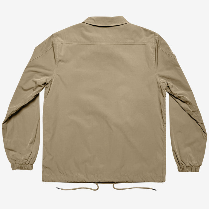 The Oaklandish Premium Coaches Jacket in khaki is showcased from the back, highlighting its simple collar, long sleeves with elasticated cuffs, and a straight hem. A drawstring is visible at the bottom hem. This water-resistant jacket boasts a clean, minimalist design without any visible logos or embellishments. Designed in men's sizing.