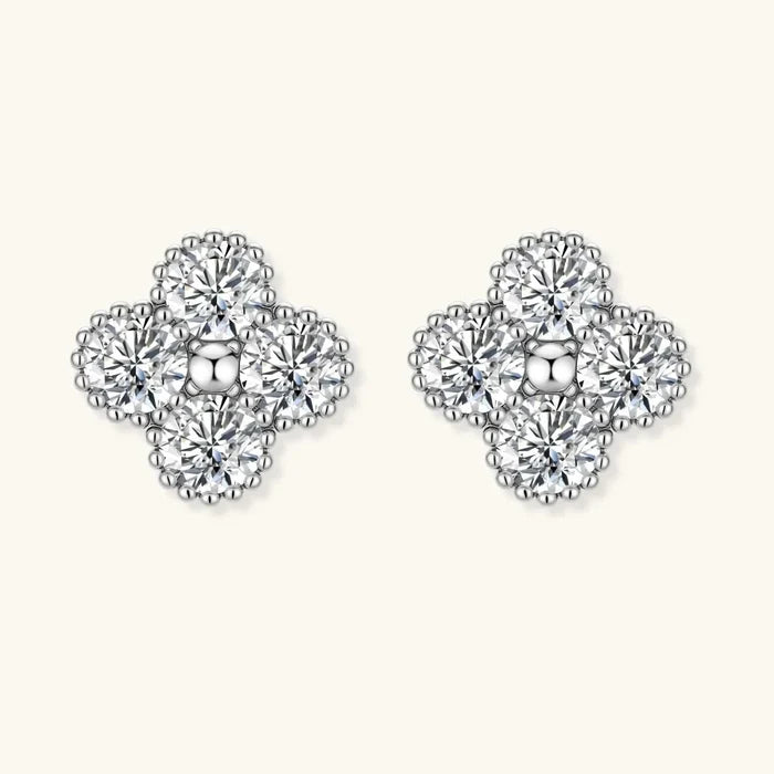 Quatrefoil Moissanite Stud Earrings in silver-toned metal, with four clear round stones and beaded clover-shaped borders.