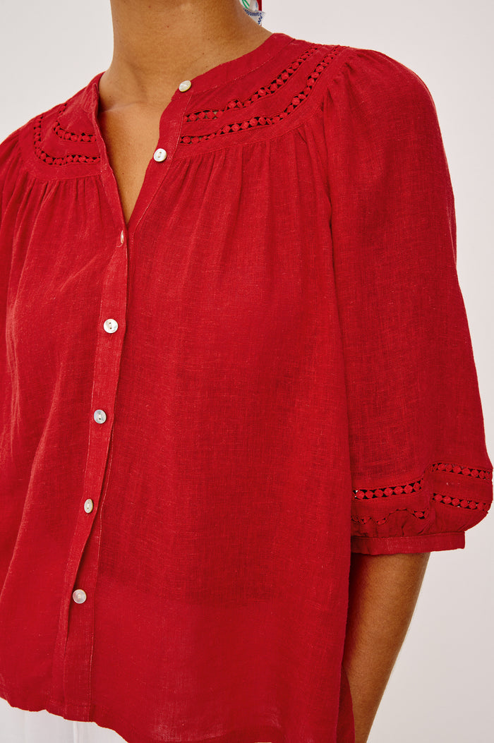 Theia Top in Luxe Linen With Crew Neckline, Front Buttons, Relaxed Fit, Embroidered Detailing, and Elbow-Length Puff Sleeves in Tomato Colorway - Upper Body Front View Featured on Model