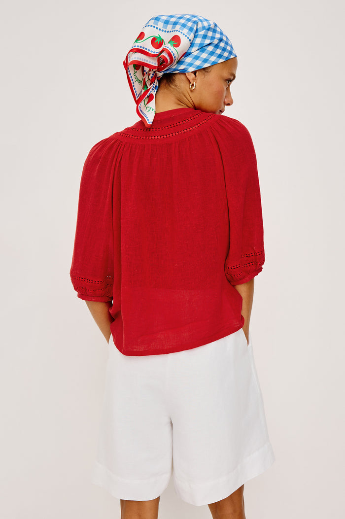 Theia Top in Luxe Linen With Crew Neckline, Front Buttons, Relaxed Fit, Embroidered Detailing, and Elbow-Length Puff Sleeves in Tomato Colorway - Upper Body Back View Featured on Model
