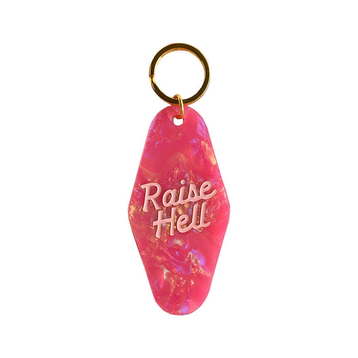 Golden Gems Raise Hell Motel keychain featuring a detailed metal design with motel branding and vintage-style lettering.