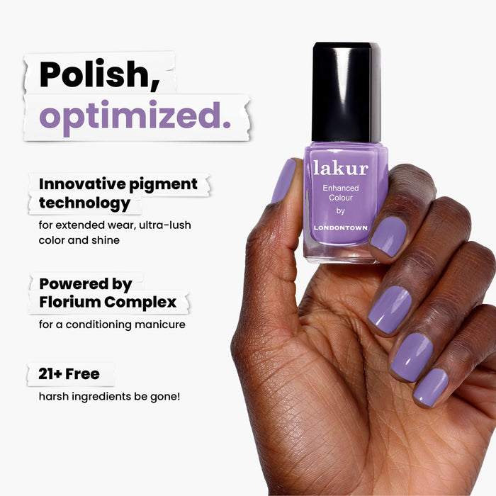 A hand with lavender-painted nails holds LONDONTOWN's Road Trip polish. It features innovative pigment technology, offers a conditioning manicure, and is free from harsh ingredients for an exciting twist on nail care.
