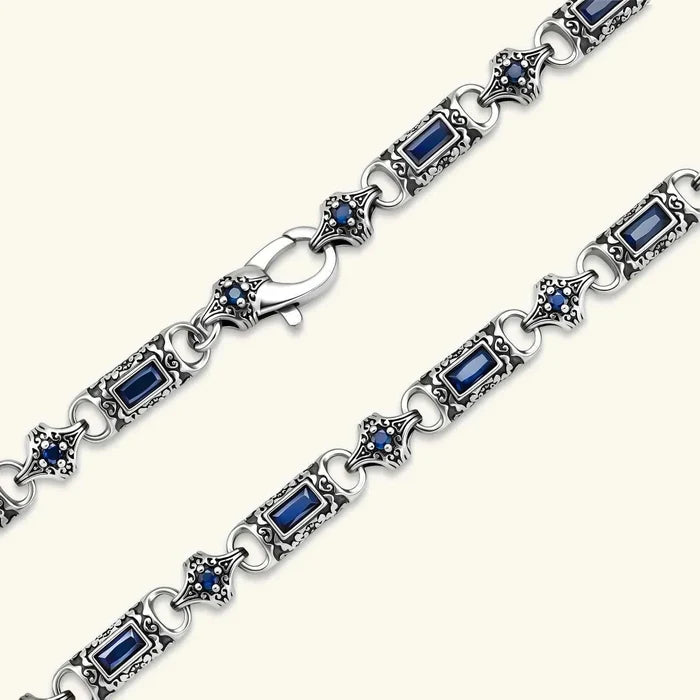 Baguette-cut and round stones necklace with deep blue gems, ornate silver-tone scrollwork links and antique finish