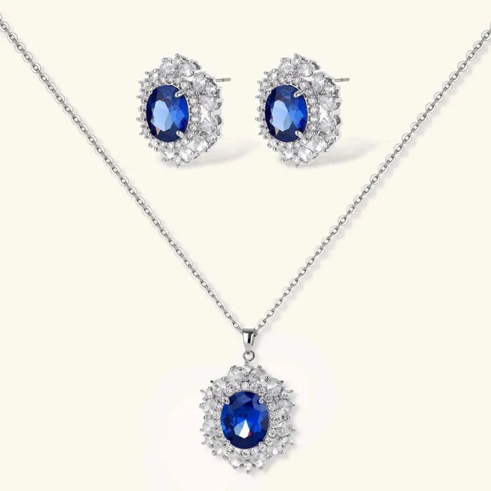 Royal Blue Zirconia Halo Necklace and matching stud earring set in silver-tone metal, with oval blue stones and clear halos.