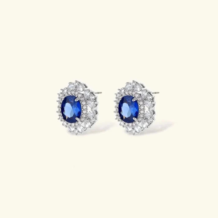 Royal Blue Zirconia Halo Necklace set with oval deep-blue stones, clear crystal halos, and silver-tone stud earrings.
