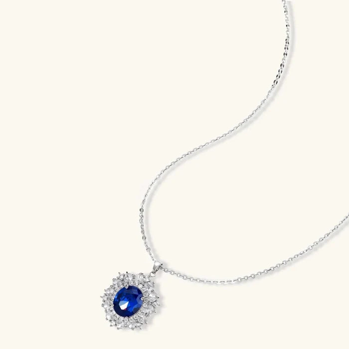 Royal Blue Zirconia Halo Necklace with a vivid oval blue stone, clear halo crystals and a fine silver-tone chain