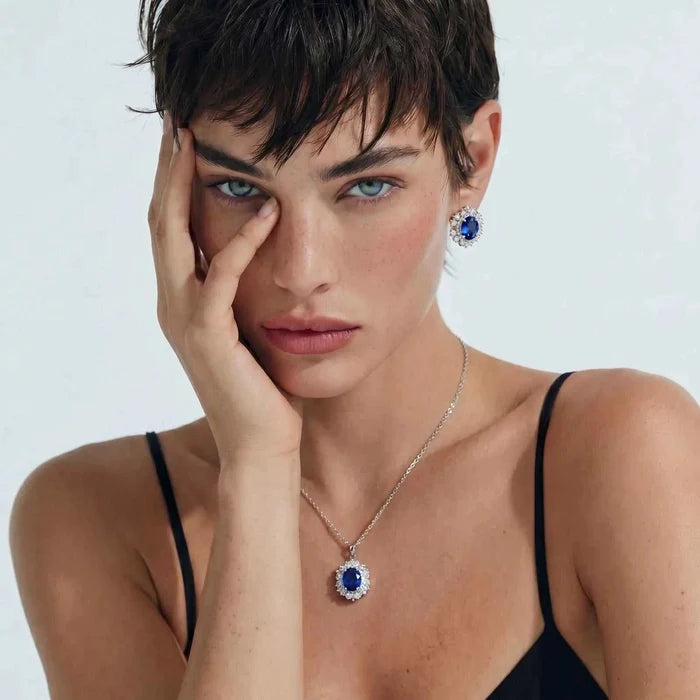 Royal Blue Zirconia Halo Necklace set in silver-tone metal, with an oval blue stone and clear halo earrings.