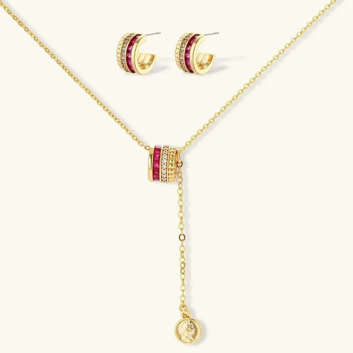 Royal Ruby Red Zirconia jewelry set with gold-tone chain necklace, ruby-red and clear-stone pendant, and matching huggie earrings