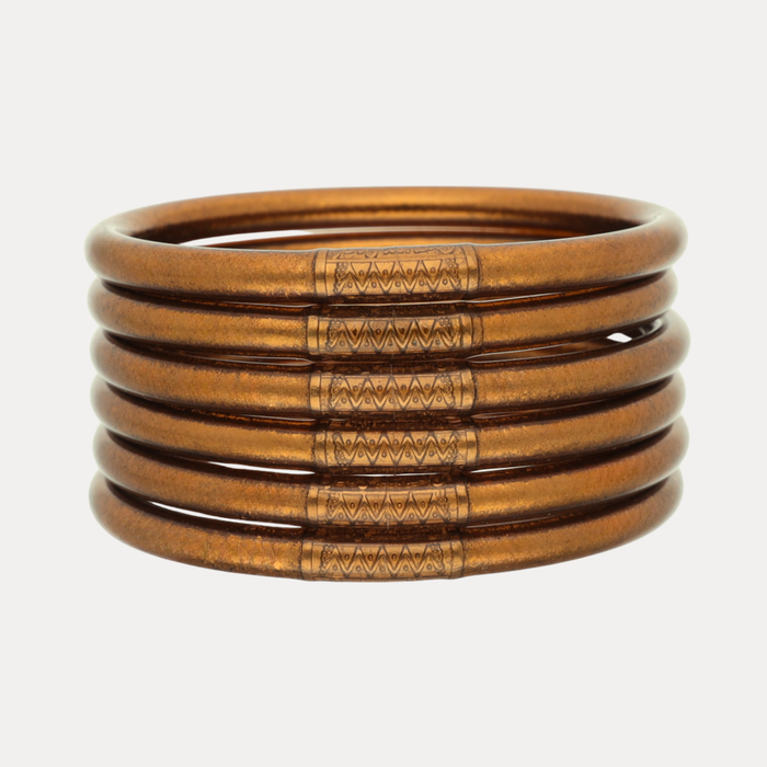 a stack of gold bracelets