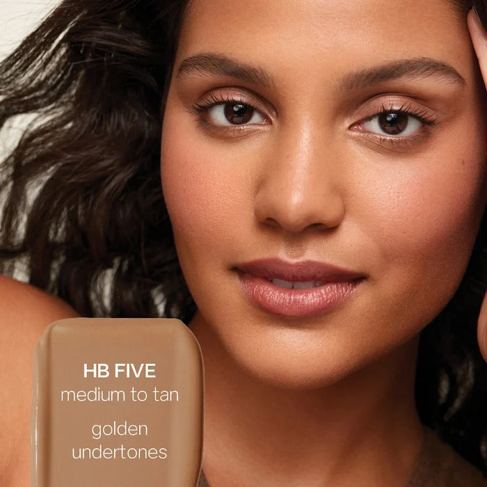 Saie Hydrabeam under eye brightener in multiple shades, showing a close-up of the sleek tube and applicator for hydrating concealer.